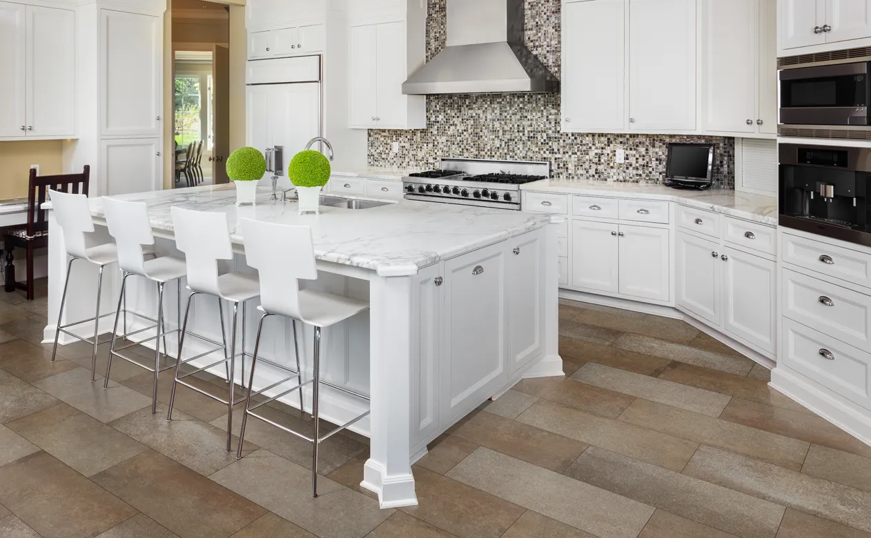 Marble countertops in kitchen with white cabinetry