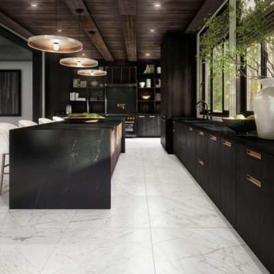 white marble floor in black contemporary kitchen with brass accents and greenery